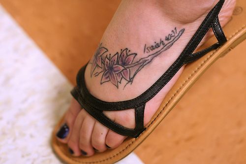 flower and star tattoos on foot. latin tattoos and meanings