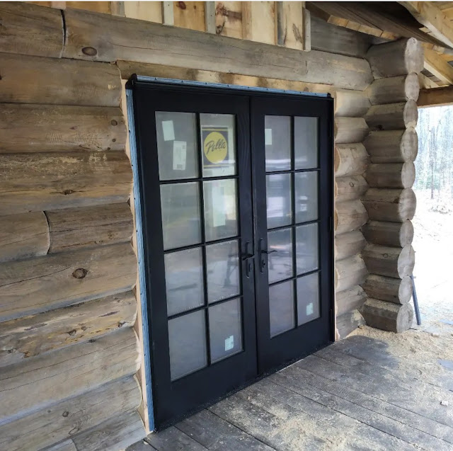 Log cabin with black french doors