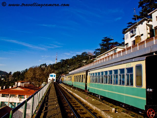 Travelling Camera @ Shimla Railway Station, Himachal Pradesh (Waiting for Himalyan Queen for back journey to Kalka): POSTED BY VJ SHARMA AT www.travellingcamera.com : Shimla Railway Station is under the administrative control of Northern Railways. It is located about 3.25 kilometers from Chotta Shimla. It has a narrow gauge railway line linked to Kalka (92 kilometers) on which the toy trains run. The journey on the toy train offers amazing experience to the travellers. Shivalik Express, Shimla Mail and Kalka Shimla Rail Motor Car (special train) pass through this station. Computerized reservation facility is provided...Himalyan Queen Waiting @ Shimla Railway Station...Don't miss the Doordarshan Tower on hill-top in this Photograph...A view of other side of Shimla.. Probably Chhota Shimla...A few minutes walk from the station is Shimla Bus Station. Just 2.5 kilometers from the railway-station is the Mall Road which is main attraction among Tourists in Shimla. The nearest airport is Shimla Airport at Jubbalhatti which is around 25 kilometers from Railway Station...A View of deep valley from Himalyan Queen @ Shimla Railway Station.Its time to depart from Shimal and forget this freshness...Main Entry to Shimla Railway Station...The route offers a panoramic views of the amazing Himalayas from the Sivalik foot hills at Kalka to several important points such as Dharampur, Solan, Kandaghat, Taradevi, Barog, Salogra, Summerhill and Shimla at an altitude of 2100 meters...