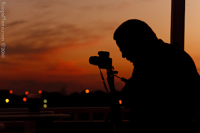 Silhouette of photographer capturing the sunset