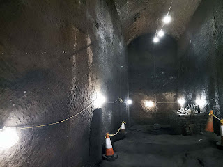 <img src="img_williamson_tunnels.jpg" alt="main cave with lights">