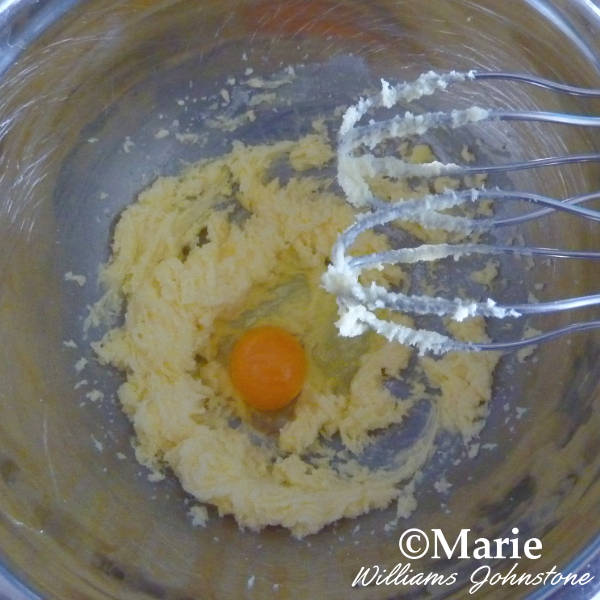 Making the vanilla cookie dough mixture in a stainless steel bowl with whisks