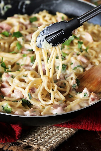 Serving Creamy Ham & Cheese Spaghetti with Tongs Image