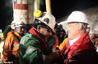 Luiz Urzua being greeted by the Chilean president