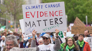 "Climate Change Evidence Matters" sign at Science March (Credit: Albin Lohr-Jones/Pacific Press/LightRocket via Getty Images) Click to Enlarge.