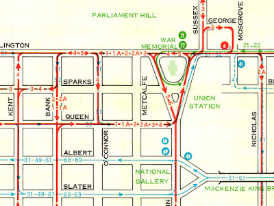 Section of a 1962 Ottawa transit map showing downtown routes where those going east on Wellington onward toward Rideau must detour down to Queen St via O'Connor to go around Confederation Square, because Wellington is one-way westbound around Confederation Square.