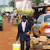 Man in suit sells water melon on the streets of Ghana