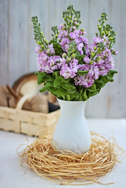 Pink Stock lowers in a white vase with raffia