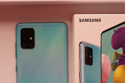 Blue Samsung A71 5G showing black quadruple camera and the back is showing the phone screen with wallpaper and the back of the phone next to it.