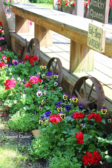 Photo of pansies and geraniums planted along the side of the deck.