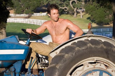 Alex O'Loughlin shirtless and driving a tractor
