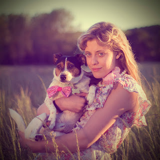 a cute girl with jack russell terrier dog in a farm
