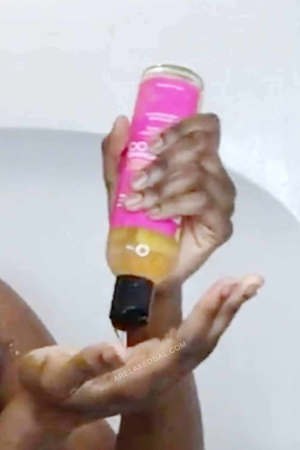 squeezing shampoo from bottle into hand to wash relaxed hair.