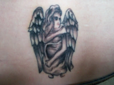 Small angel dark ink tattoo