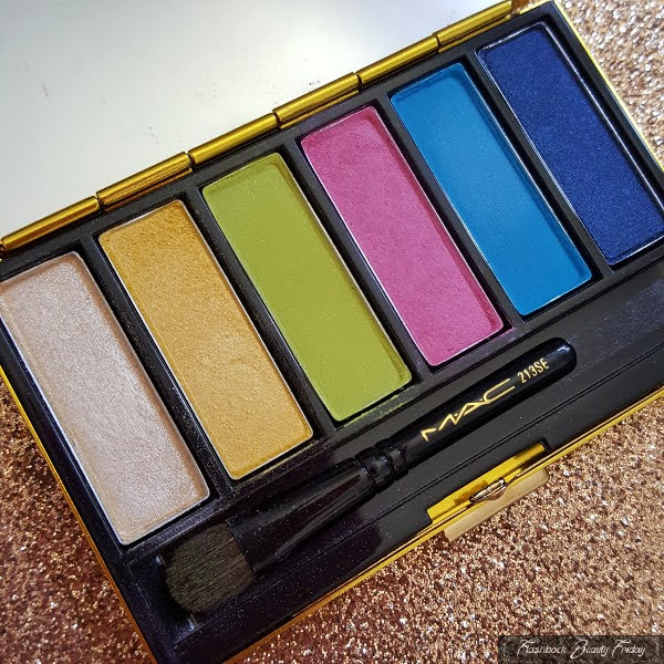 inside of eyeshadow palette with 6 colourful powder shadows and small eyeshadow brush