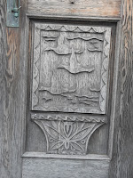 Wood paneling carved with flying water birds.