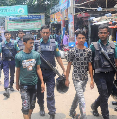 Police detain suspected drug dealers during a raid in Dhaka on June 20. 