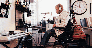 photo of wheelchair bound man using computer