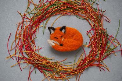 Fox sleeping in macrame threads