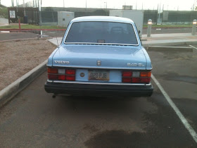 Rear view of blue 1986-1992 Volvo 240 GL in parking lot