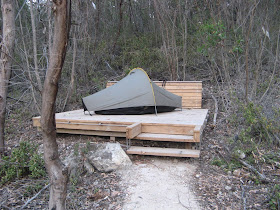 There are timber tent platforms at Cup Gum Campsite, and in the tour group area of Hakea Campsite. Some like this one feature benches (behind tent). There are bars around the sides and pop-up tent pegs to secure your tent to (bring some string or rope)