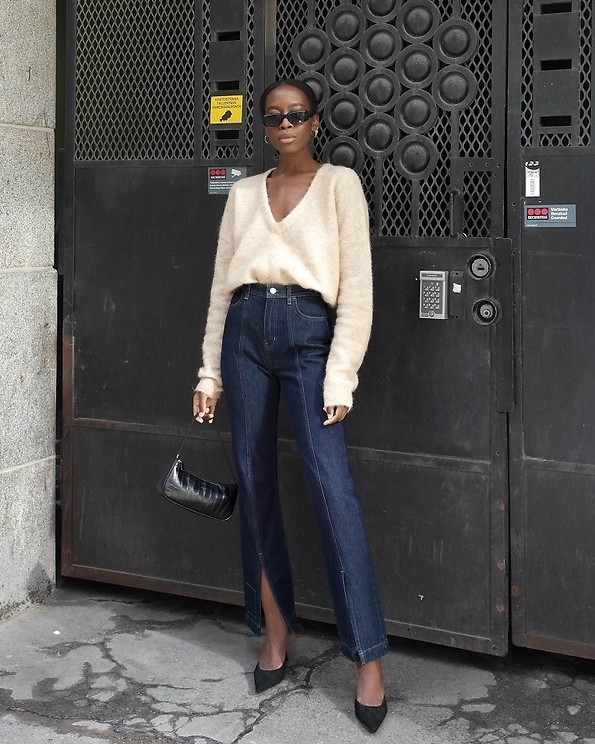 This Stylish Scandi-Girl Outfit Is Perfect for Spring — Sylvie Mus in a v-neck sweater, '90s shoulder bag, split-hem jeans, and black suede pumps