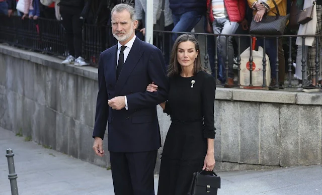 Queen Letizia wore a black tweed dress and pearl diamond brooch. King Felipe attended Fernando Gomez Acebo's funeral