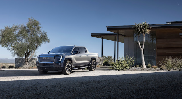 2024 GMC Sierra EV Denali Edition 1 - open space, in front of a house.