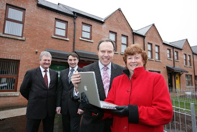 Photo (c) fibresystems.org - Enterprise Minister, Nigel Dodds visits the site of the Next Generation High Speed Broadband Trials on the Ormeau Road, Belfast. Pictured from left to right are: Alan McLeod, Virgin Media's New Developments Manager; John Simpson, Managing Director of Bytel Ltd; Minister Nigel Dodds; Alderman Geraldine Rice, Chair of Clanmil Housing Association.