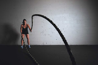 Woman using ropes at a gym