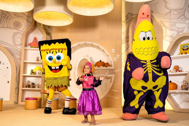 SpongeBob and Patrick with a child wearing Halloween costumes