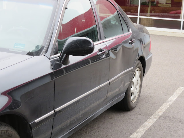 Dented rear door on Acura RL before repairs at Almost Everything Auto Body