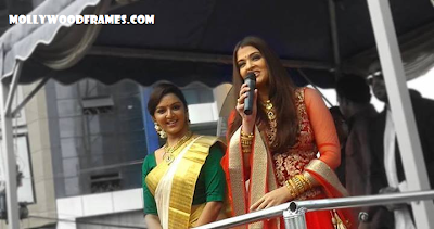 photos of Aish and Manju for showroom inauguration.