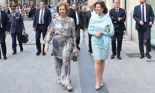 Queen Sofia and Queen Silvia attended a concert in Salamanca. Silvia wore a lace dress, Sofia wore a floral print silk jumpsuit