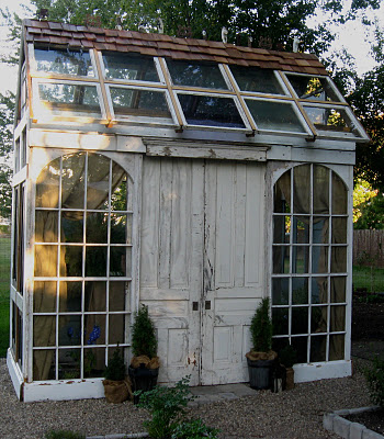 love the arched windows and old doors used in this greenhouse by ...