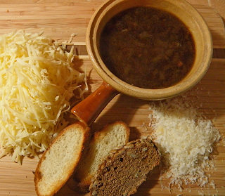 Crock of French Onion Soup with Sliced Bread and Grated Cheeses