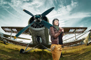 A woman pilot dressed in the style of Amelia Earhart