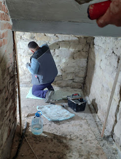 Halil is brushing the walls to remove dust