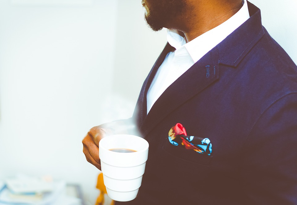 Elegant Business man having a cup of coffee