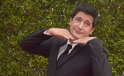 Ken Marino making a goofy pose with his hands under his chin