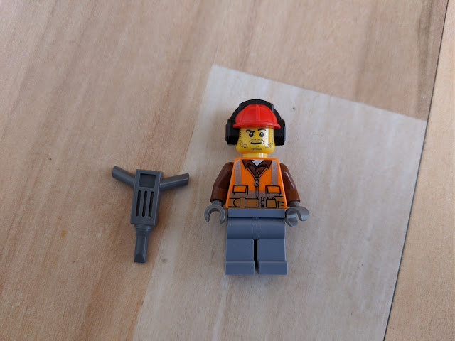 Picture of the construction worker and the pick hammer; front view