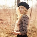 Blonde girl with a hat in woods