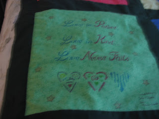 Green print fabric with fabric paint hearts and message.