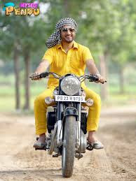 Man in yellow riding a bullet bike in the village