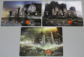 Three play mats, each abut 7 inches by 5 inches (18 cm by 13 cm), with different background artwork on each one. The one on the upper left shows a castle on the coast with a series of cliffs behind it. The one on the upper right shows a large and imposing castle on rocky terrain. The one on the bottom shows ocean waves crashing against a cliff during a rainstorm. All three mats have three sections. A small rectangle in the bottom right of each mat shows how many players that mat is used for: 6 Players with 2 Minions of Mordred for the upper left mat, 10 Players with 4 Minions of Mordred for the upper right mat, and 8 Players with 3 Minions of Mordred for the bottom mat. To the right of this rectangle is the Vote Track, a row of five circular spaces numbered 1 through 5, with the fifth space coloured red. The vote track is identical on all three mats. Running along the centre of the mat, from left to right, is a row of three large circular spaces, each with a small circular space overlapping it slightly below it and to the right of it. On the 6 player mat, the spaces are labelled: Quest 1 - 2; Quest 2 - 3; Quest 3 - 4; Quest 4 - 3; Quest 5 - 4. The 10 player mat and the 8 player mat are both labelled: Quest 1 - 3; Quest 2 - 4; Quest 3 - 4; Quest 4 - 5; Quest 5 - 5. These two mats also have an additional label above the space for quest 4 that reads: Two Fails Required.
