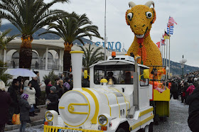 Pic of carnival float - small white train in front with goat out of lemons and oranges behind