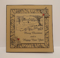 Christmas card on kraft card with black stamping and red holly berries