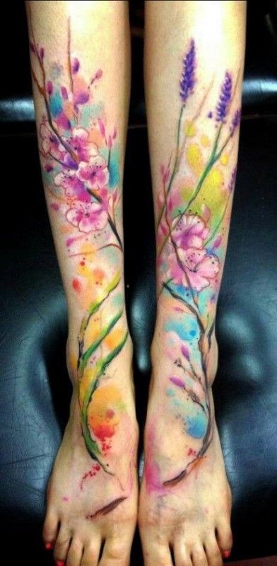 Nice watercolor flowers tattoo on feet by Adam Kremer