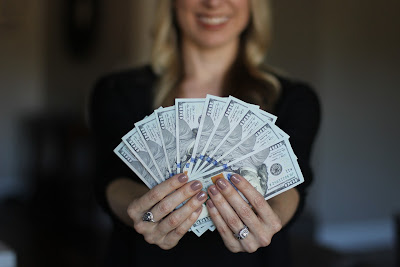 Girl in black shows American currency notes