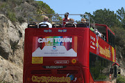 The Big Red Bus driving down from the base of Table Mountain (big red bus logo)